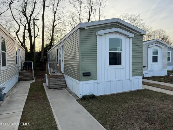 a view of a small house with a yard