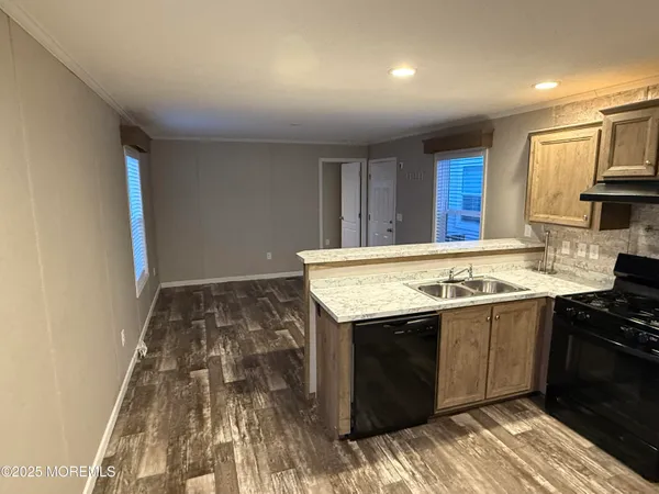 a kitchen with a sink and a stove top oven