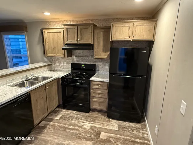 a kitchen with a refrigerator stove and sink