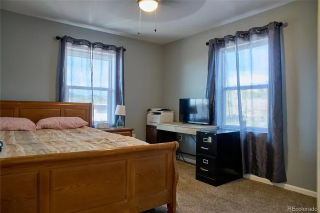 a bedroom with a large bed and a window