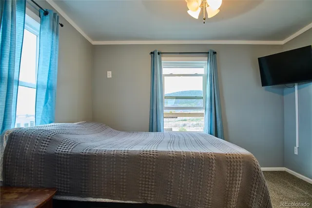 a bedroom with a bed and flat screen tv