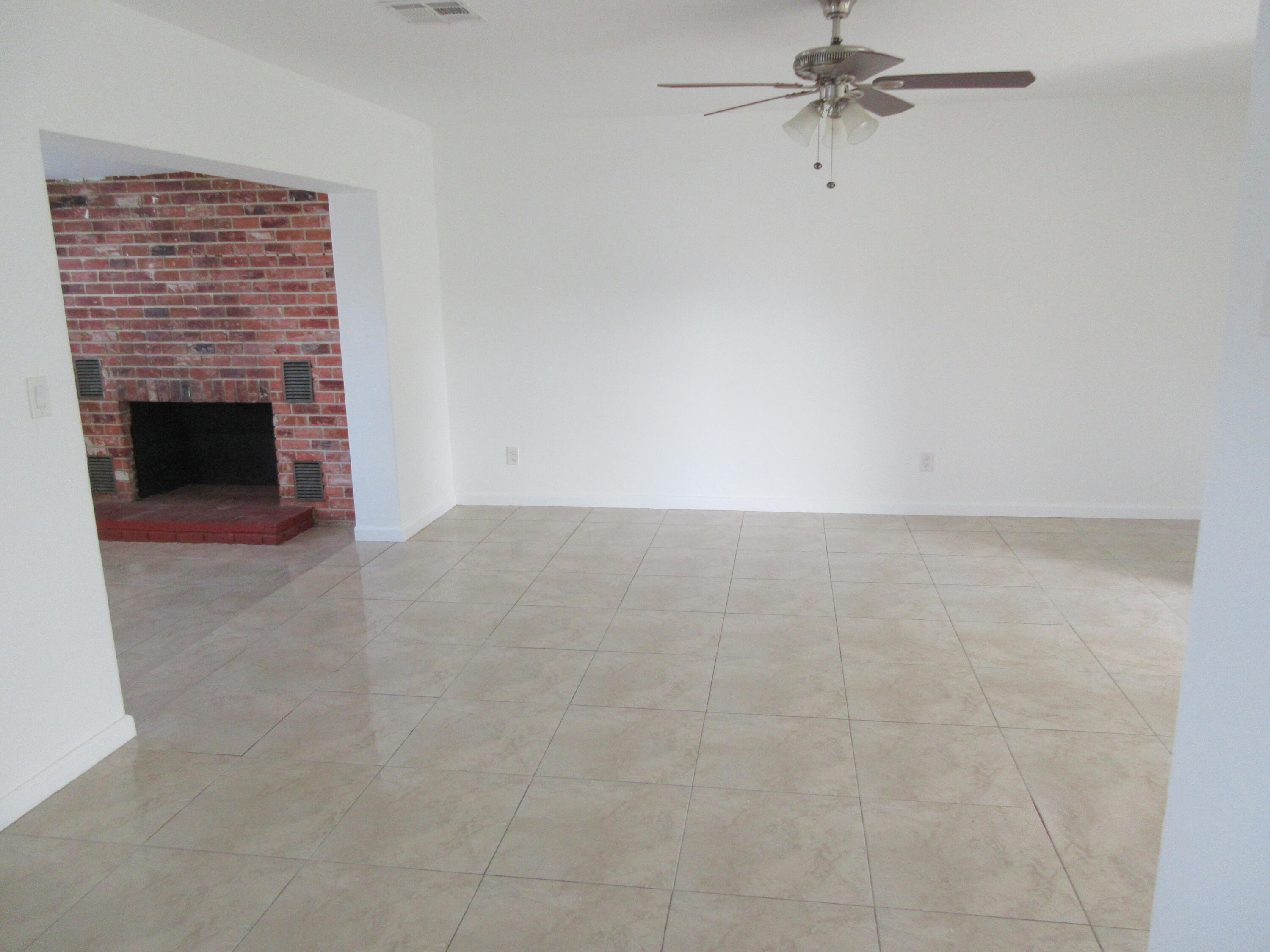 3801 Northwest 6th Street Lauderhill, FL 33311 - Photo 3 of 13 a view of an empty room with a fireplace