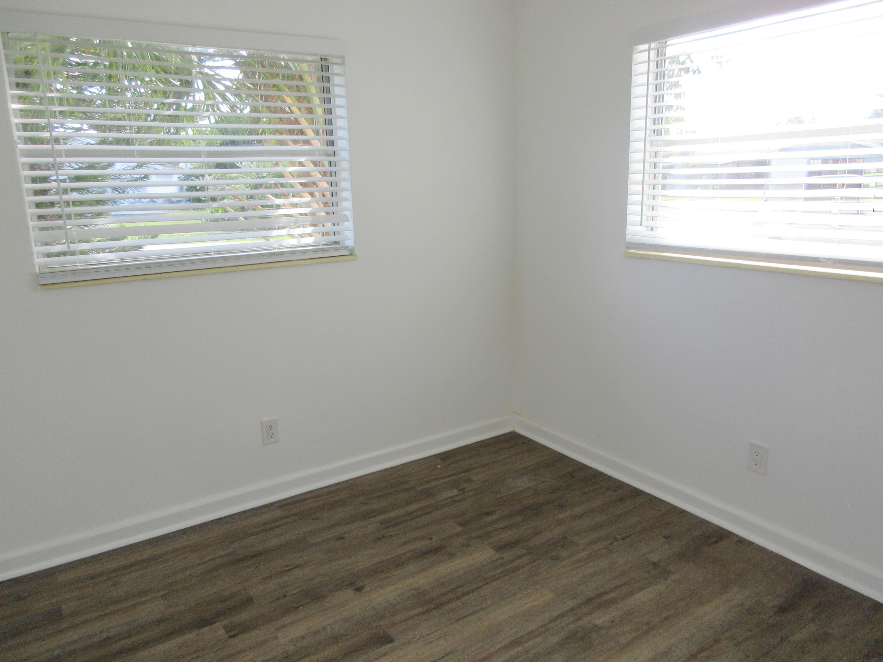 3801 Northwest 6th Street Lauderhill, FL 33311 - Photo 5 of 13 a view of an empty room with wooden floor and a window