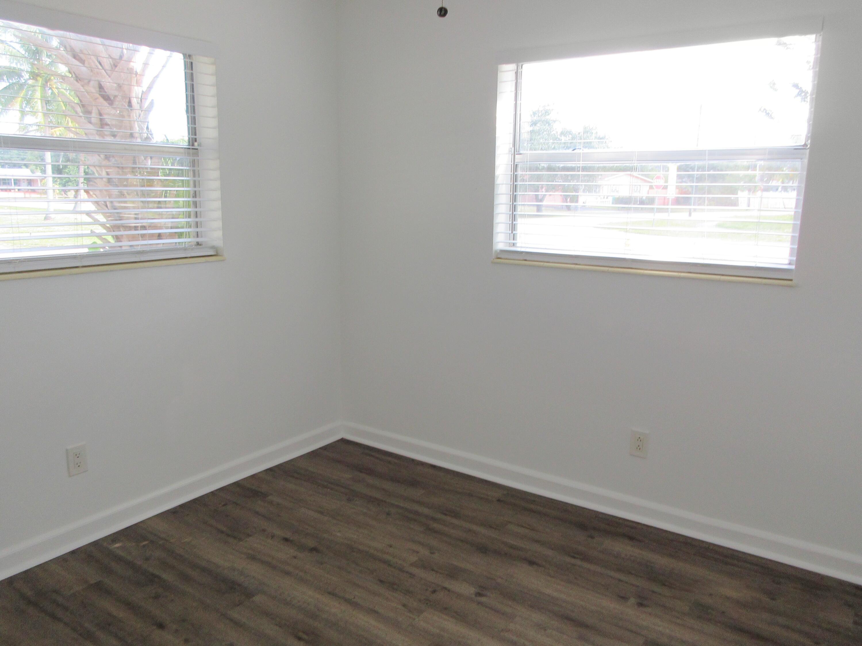3801 Northwest 6th Street Lauderhill, FL 33311 - Photo 6 of 13 an empty room with wooden floor and windows