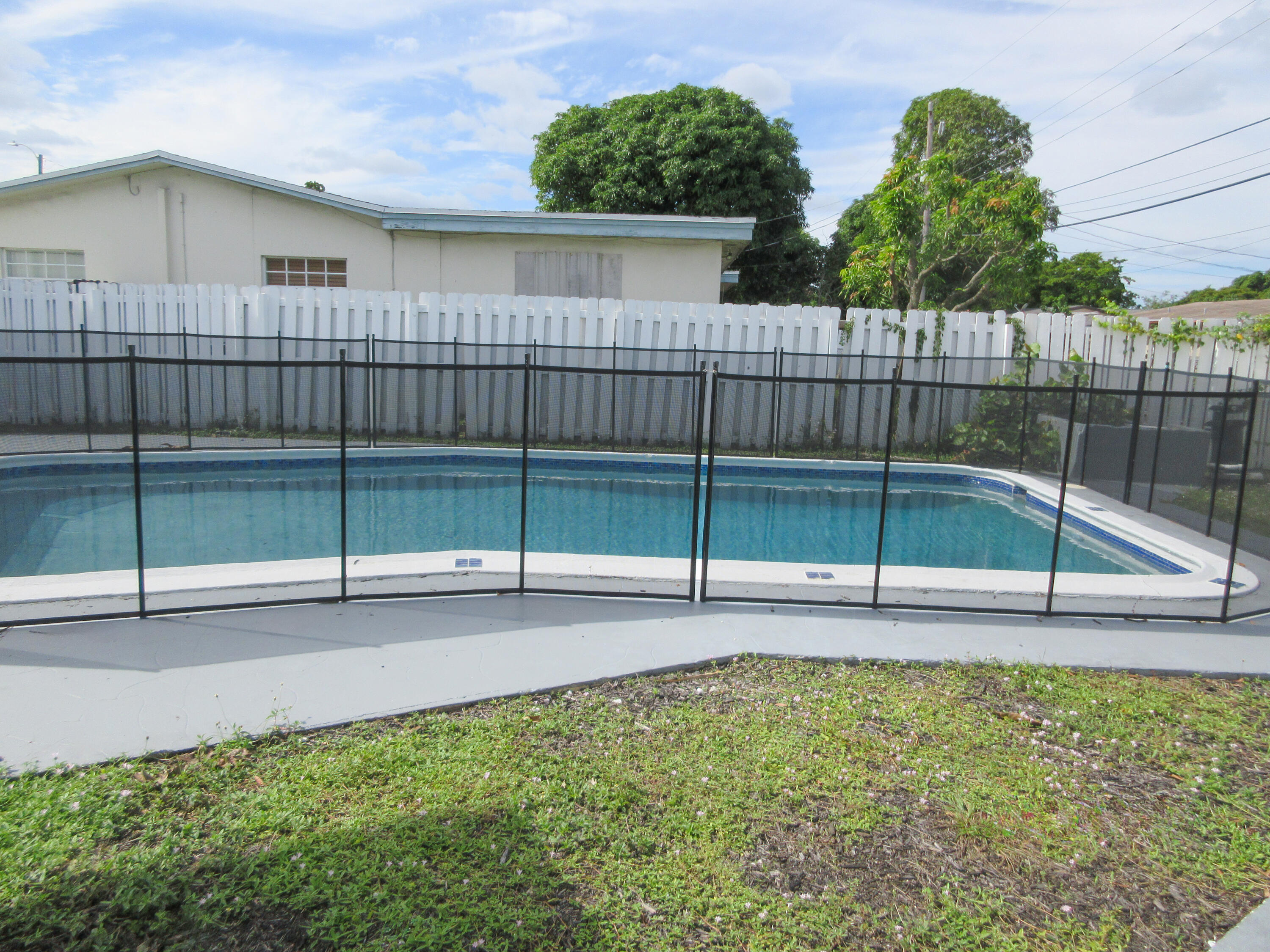 3801 Northwest 6th Street Lauderhill, FL 33311 - Photo 10 of 13 a view of a backyard with a fence