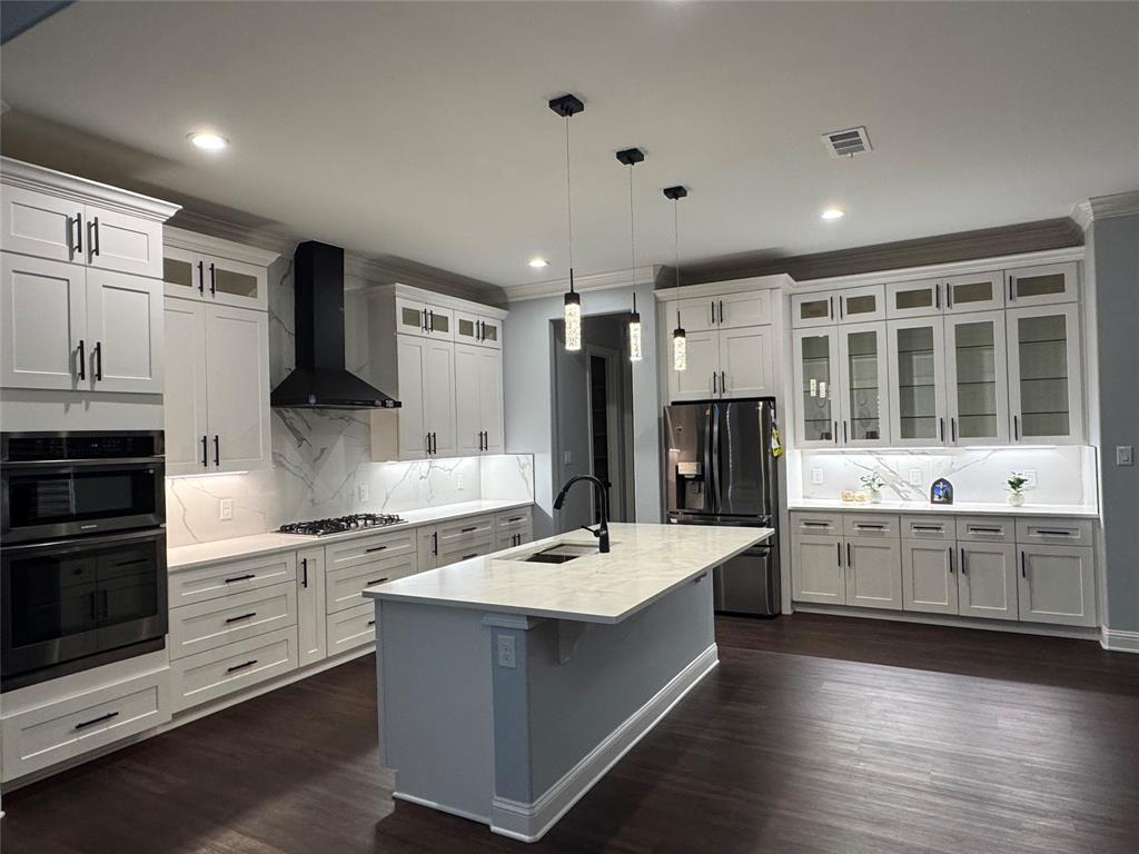 165 Circle Drive Combine, TX 75159 - Photo 5 of 10 a large kitchen with stainless steel appliances kitchen island granite countertop a stove and a refrigerator