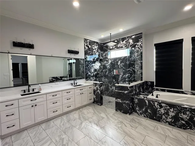 a bathroom with double vanity and a mirror