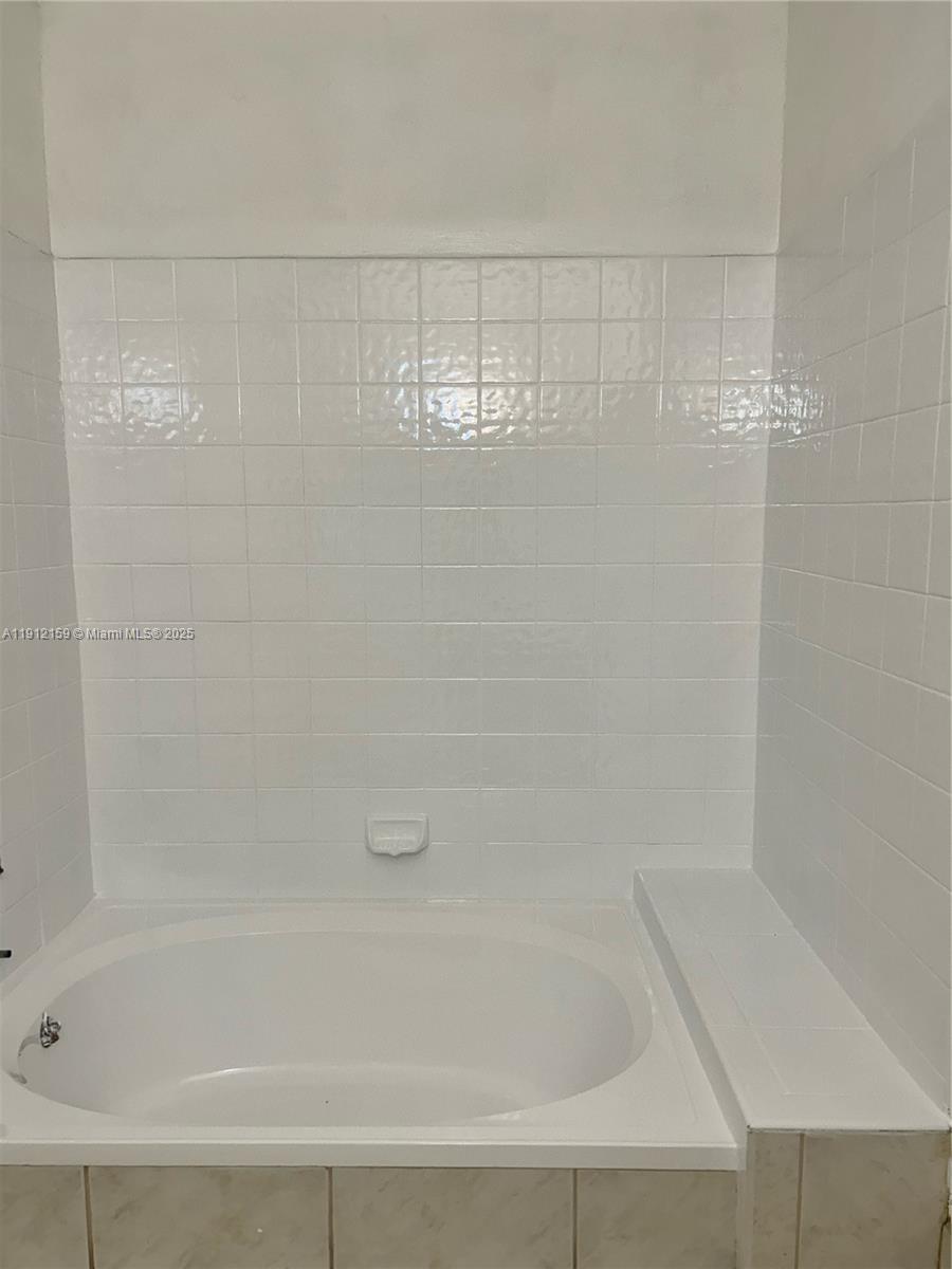 1111 Southwest 84th Terrace Pembroke Pines, FL 33025 - Photo 8 of 11 a bathroom with a shower and a bathtub