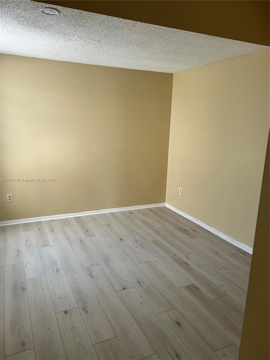 1111 Southwest 84th Terrace Pembroke Pines, FL 33025 - Photo 10 of 11 an empty room with wooden floor