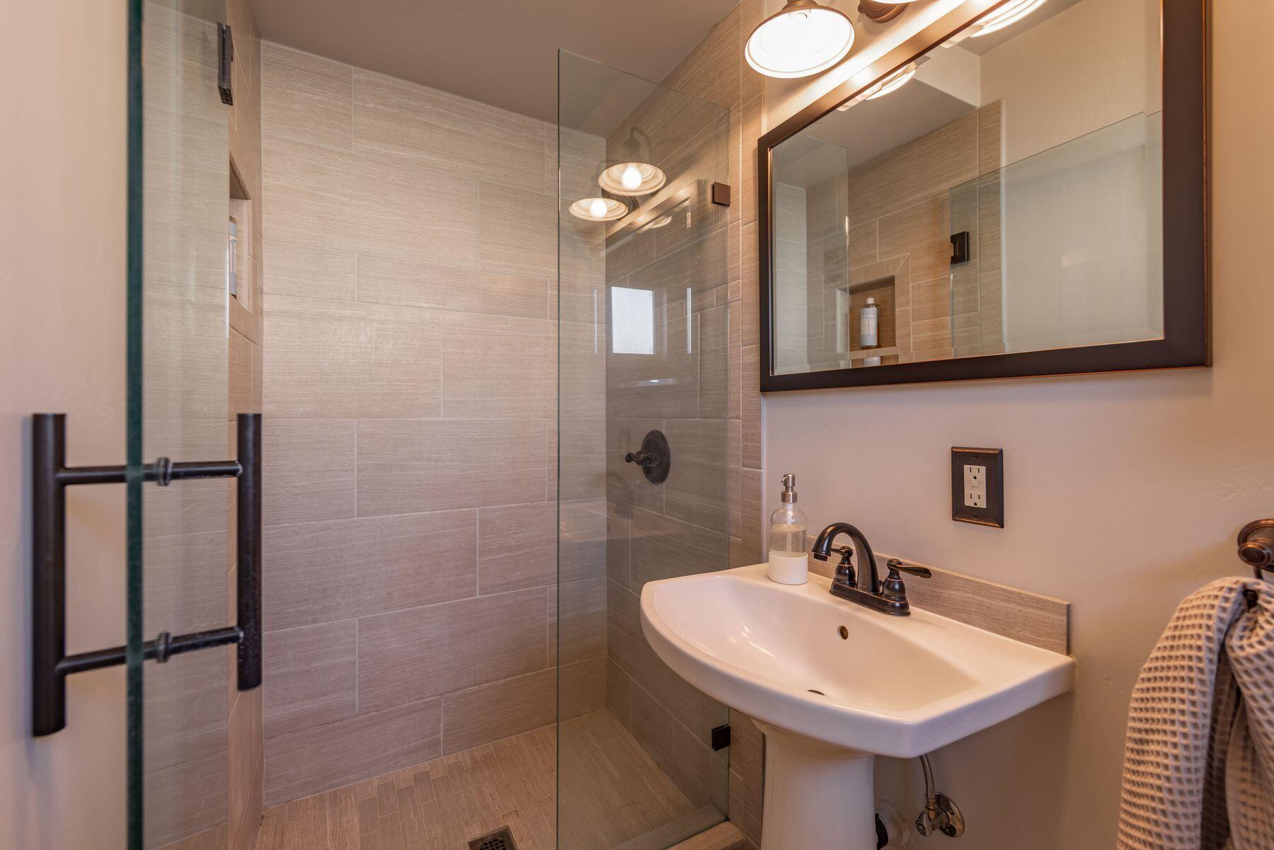 351 Sunset Avenue Oak View, CA 93022 - Photo 37 of 39 a bathroom with a sink a mirror and a shower