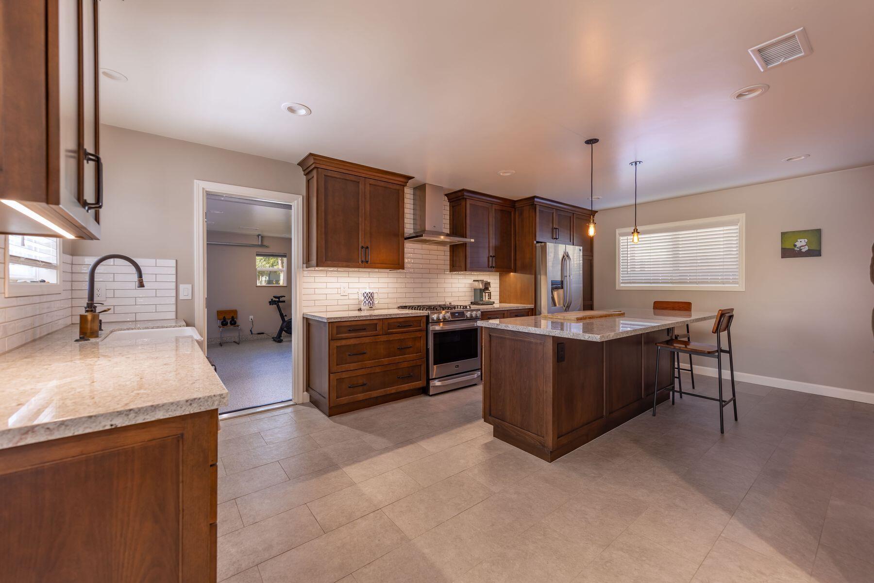 351 Sunset Avenue Oak View, CA 93022 - Photo 4 of 39 a kitchen with stainless steel appliances kitchen island granite countertop a sink and a stove