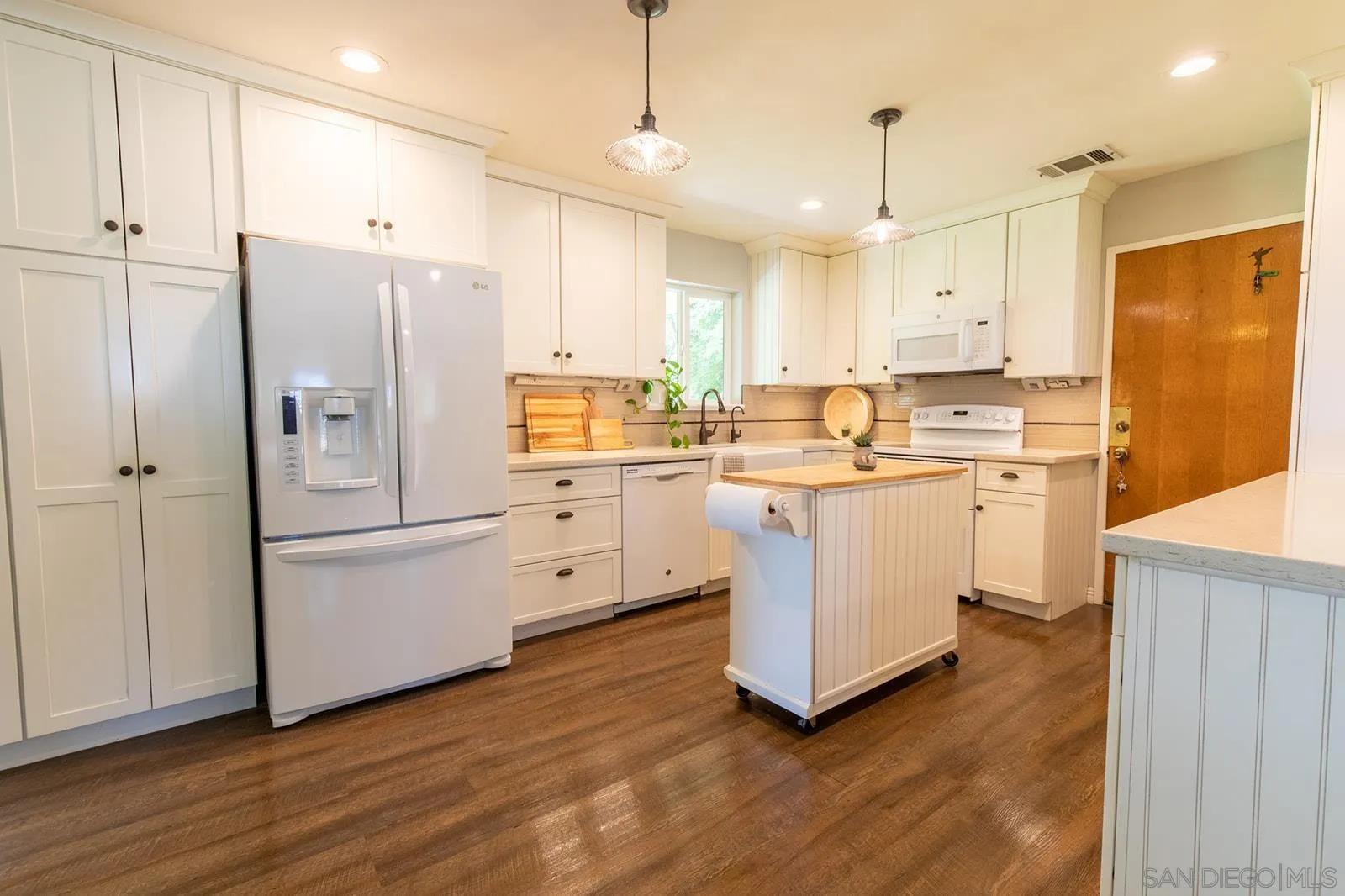 5754 Brandt Road Brawley, CA 92227 - Photo 20 of 48 a kitchen with white cabinets and white appliances