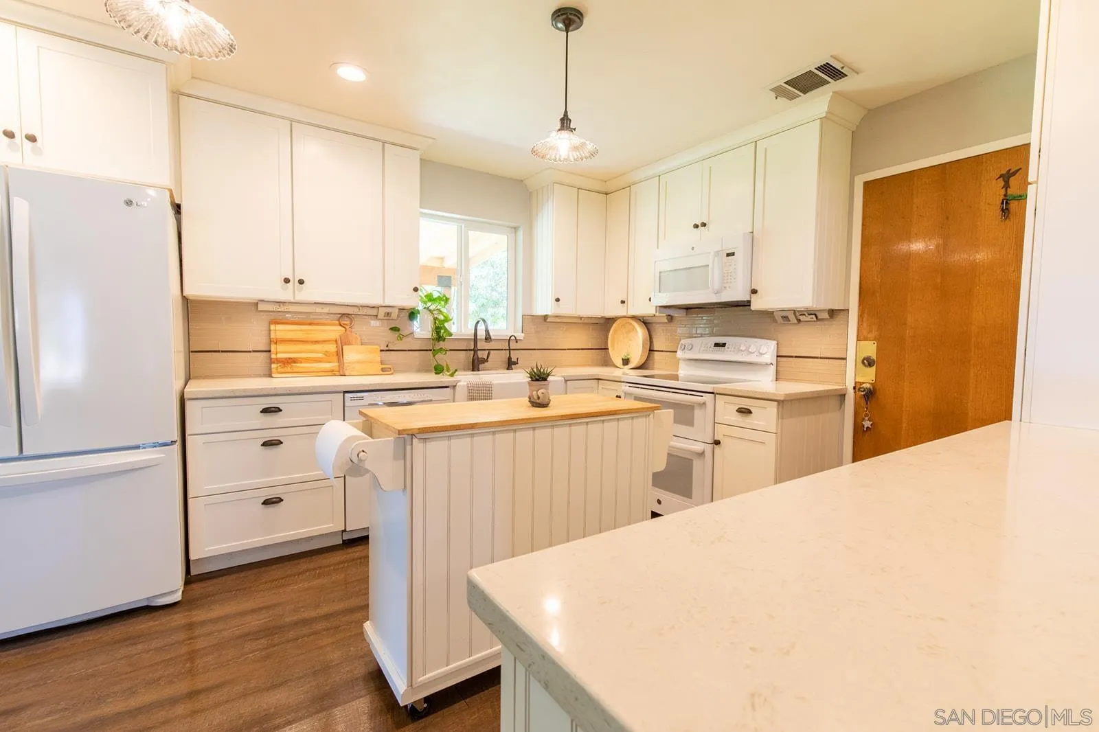 5754 Brandt Road Brawley, CA 92227 - Photo 22 of 48 a kitchen with white cabinets and white appliances