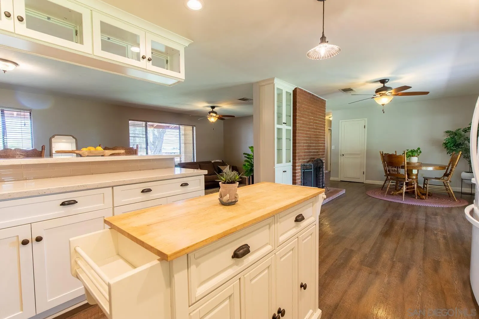 5754 Brandt Road Brawley, CA 92227 - Photo 23 of 48 a view of a kitchen counter space a sink wooden floor and living room view