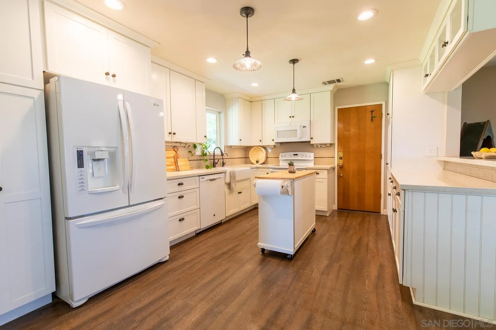 5754 Brandt Road Brawley, CA 92227 - Photo 25 of 48 a kitchen with white cabinets and stainless steel appliances