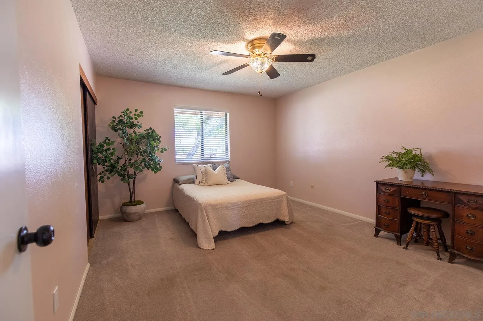 5754 Brandt Road Brawley, CA 92227 - Photo 31 of 48 a spacious bedroom with a bed and a potted plant