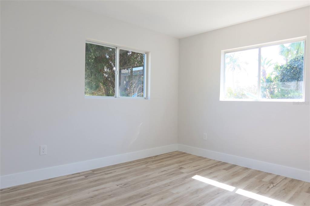 4240 Floramar Terrace New Port Richey, FL 34652 - Photo 17 of 51 an empty room with wooden floor and a window