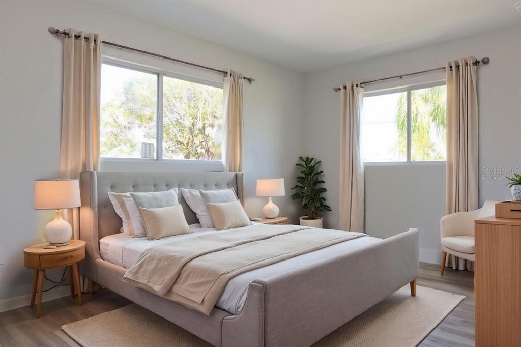 4240 Floramar Terrace New Port Richey, FL 34652 - Photo 20 of 51 a bedroom with a large bed and a lamp next to a window