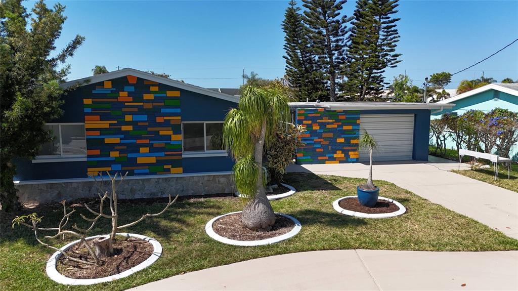 4240 Floramar Terrace New Port Richey, FL 34652 - Photo 2 of 51 a backyard of a house with lots of green space and plants