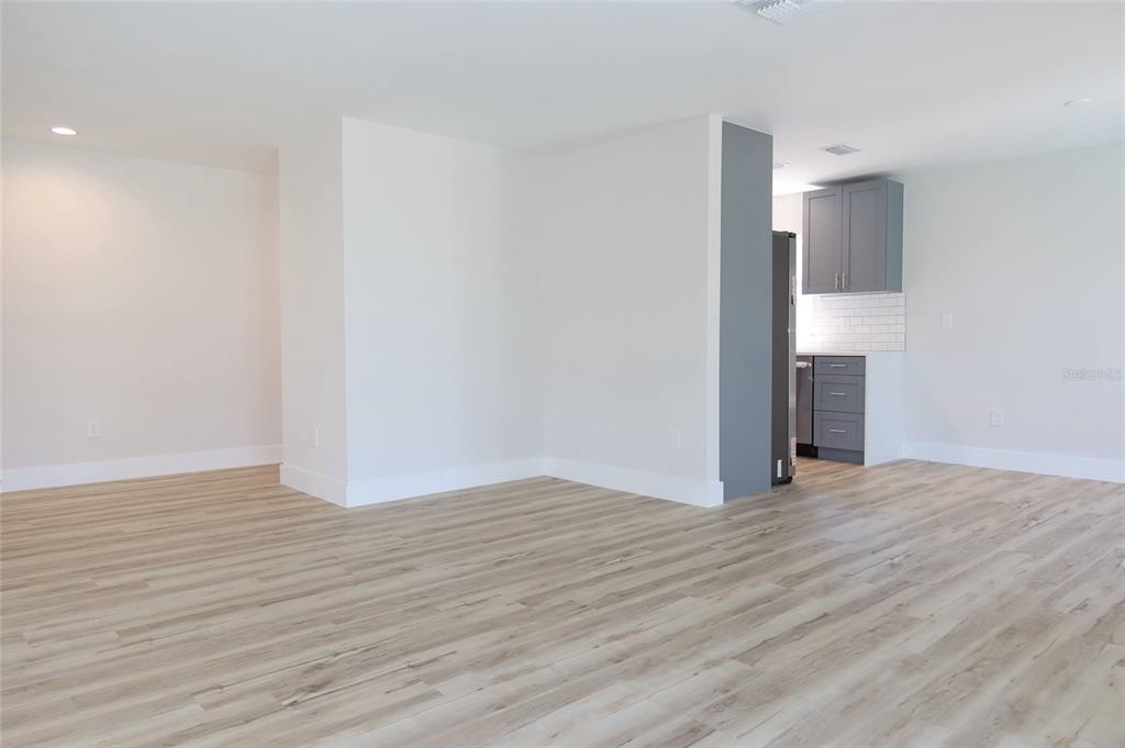 4240 Floramar Terrace New Port Richey, FL 34652 - Photo 23 of 51 a view of an empty room with wooden floor and a window