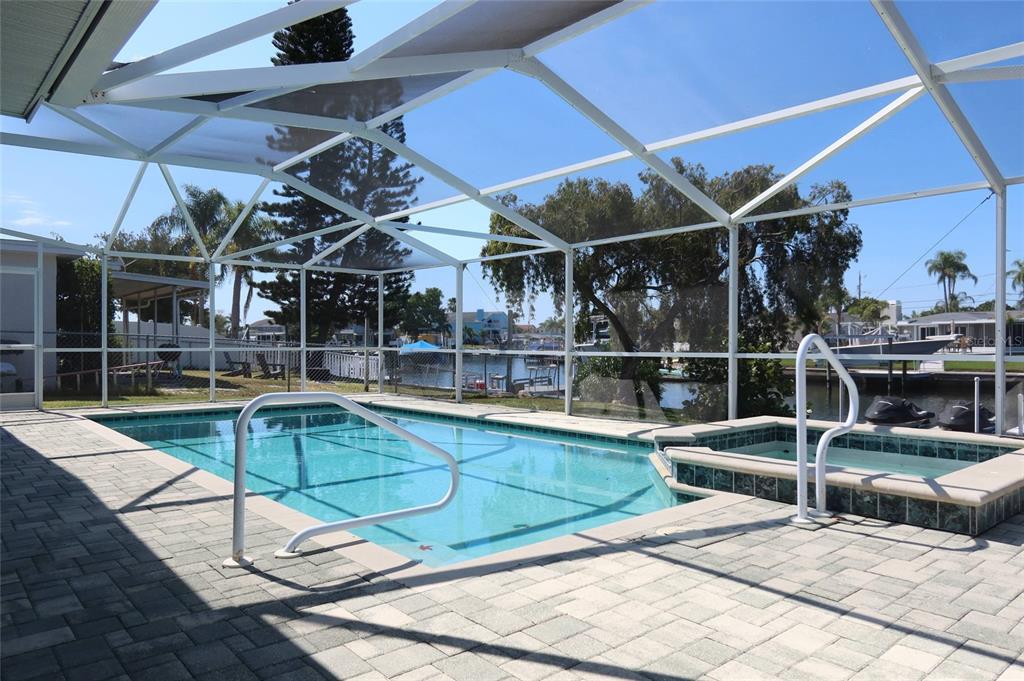4240 Floramar Terrace New Port Richey, FL 34652 - Photo 27 of 51 a view of a swimming pool with a patio