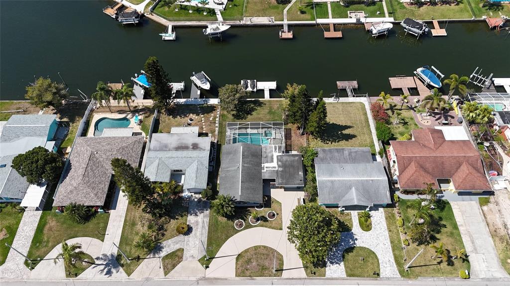 4240 Floramar Terrace New Port Richey, FL 34652 - Photo 45 of 51 an aerial view of a house with a lake view