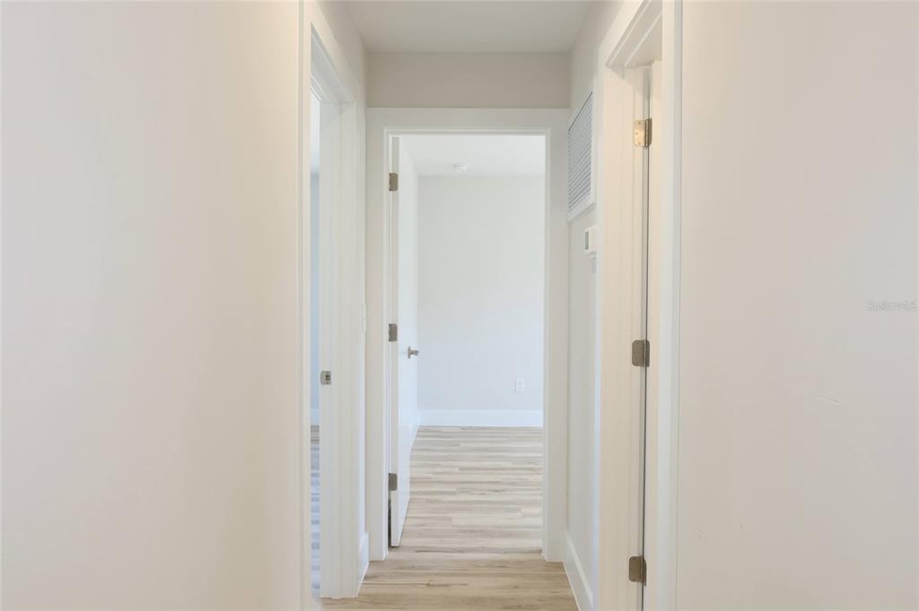 4240 Floramar Terrace New Port Richey, FL 34652 - Photo 8 of 51 a view of a hallway with wooden floor