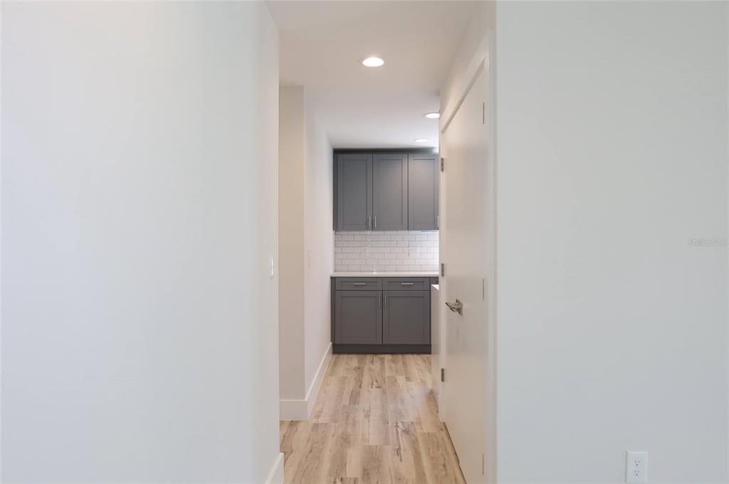 4240 Floramar Terrace New Port Richey, FL 34652 - Photo 9 of 51 a view of walk in closet with wooden floor