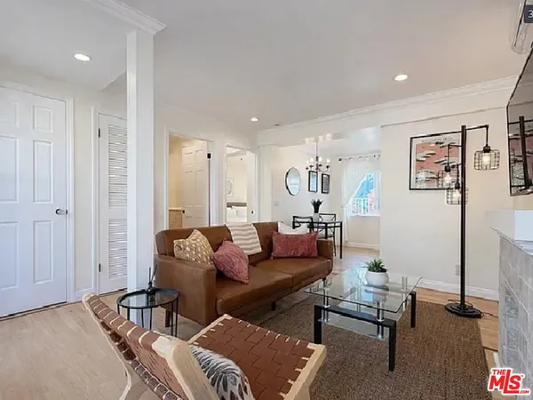 a kitchen with stainless steel appliances kitchen island granite countertop a stove a sink dishwasher and a refrigerator with wooden floor