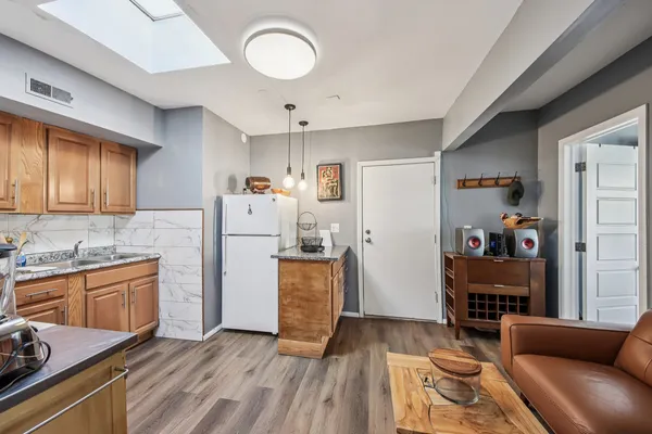 a kitchen with a refrigerator and a sink