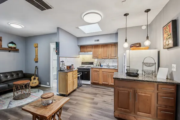 a kitchen with a refrigerator stove and sink