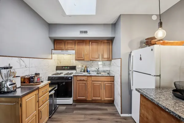 a kitchen with a sink a stove and refrigerator