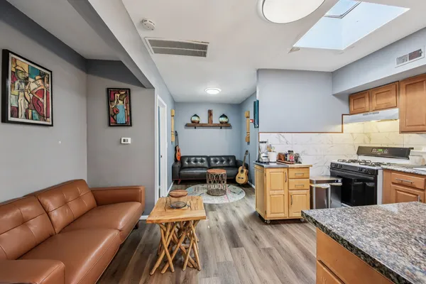 a living room with furniture and kitchen view