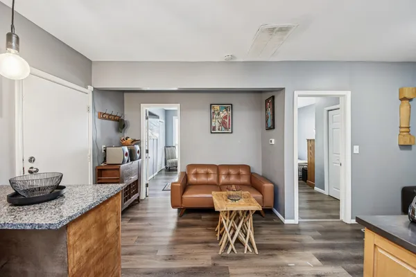 a living room with furniture and a wooden floor