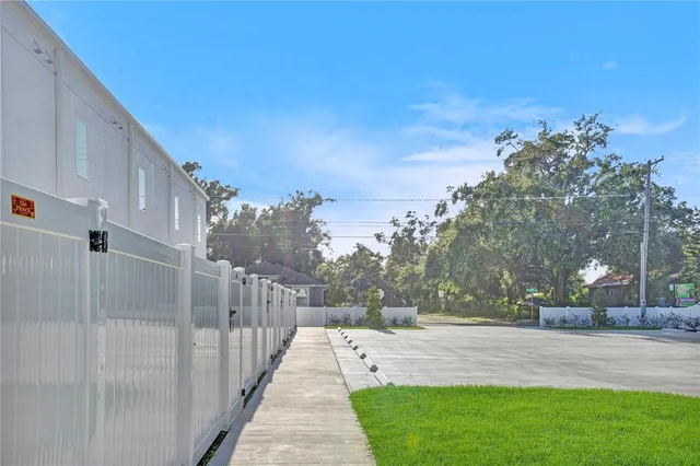 a view of a pathway with a wrought fence