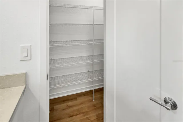 a view of walk in closet with empty racks