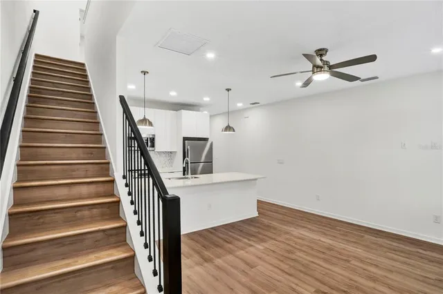 a view of entryway and hall with wooden floor