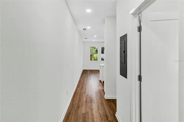 a view of hallway with wooden floor