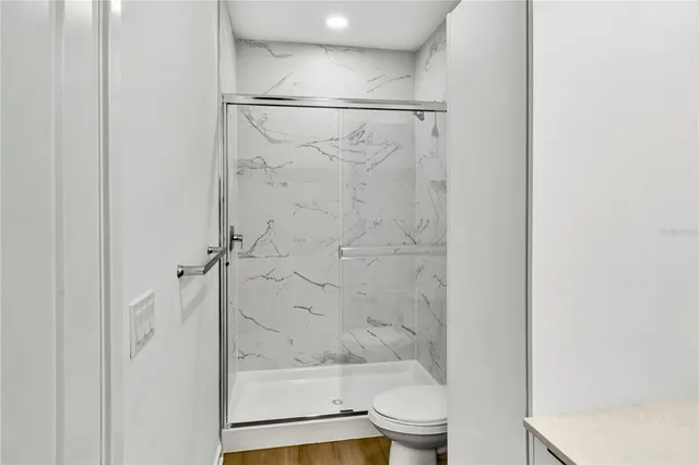 a bathroom with a glass shower door