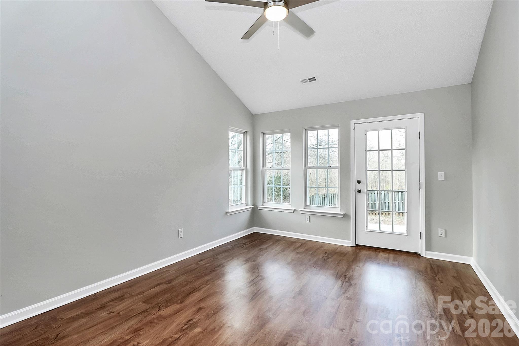 1044 Sandy Point Drive Southwest Concord, NC 28025 - Photo 15 of 32 a view of an empty room with a window and wooden floor