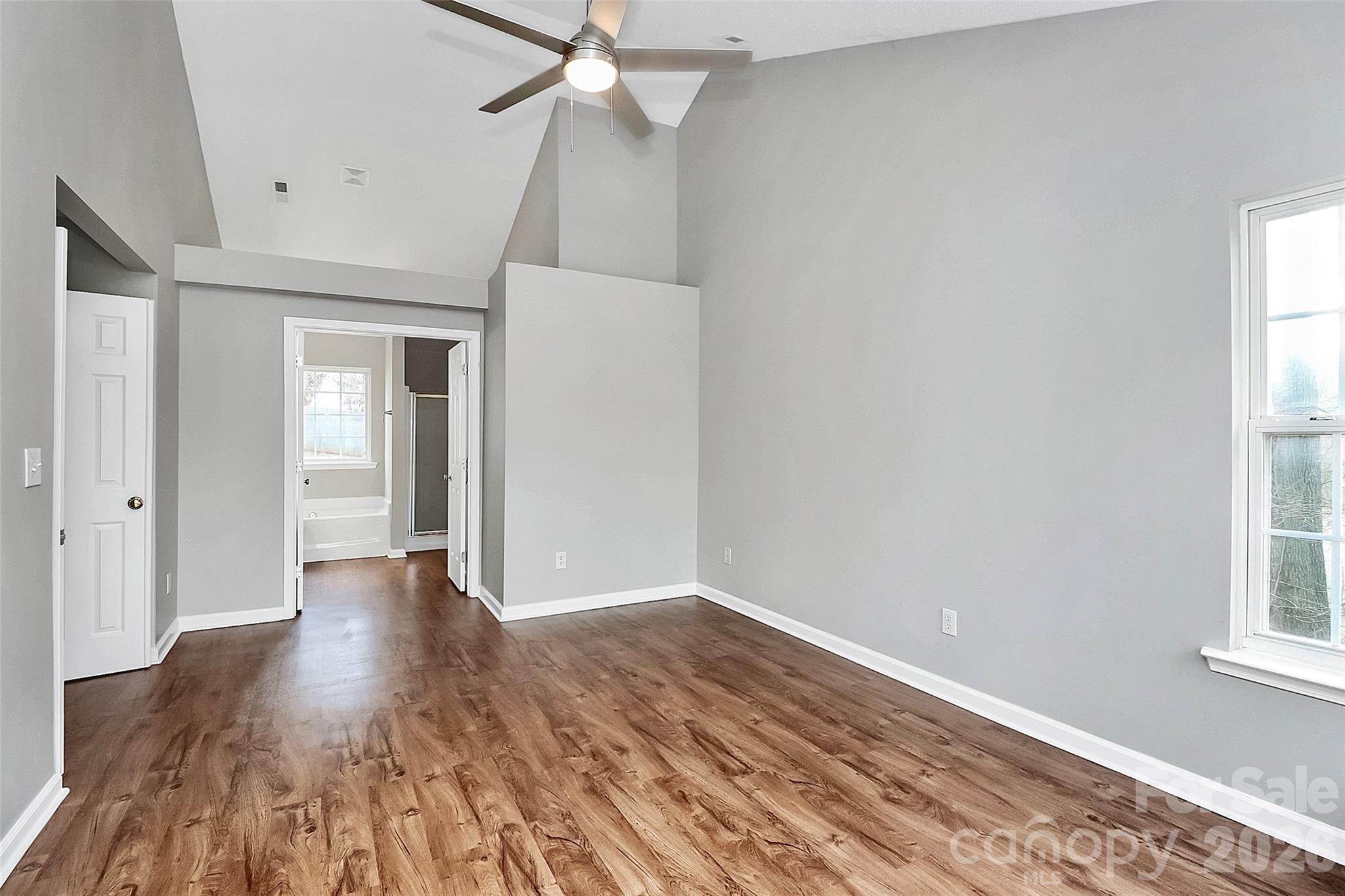1044 Sandy Point Drive Southwest Concord, NC 28025 - Photo 16 of 32 wooden floor in an empty room with a window