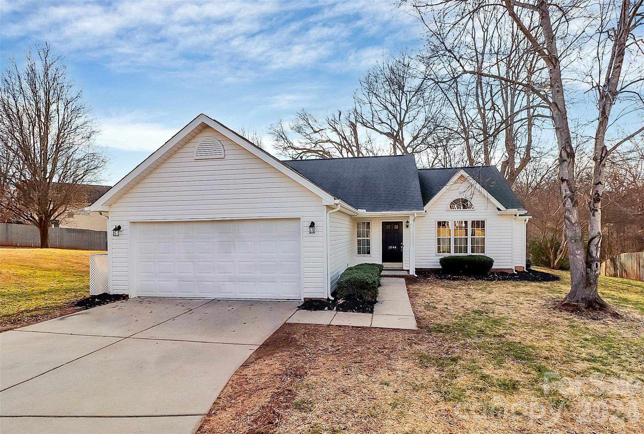 1044 Sandy Point Drive Southwest Concord, NC 28025 - Photo 2 of 32 a view of a house with a yard
