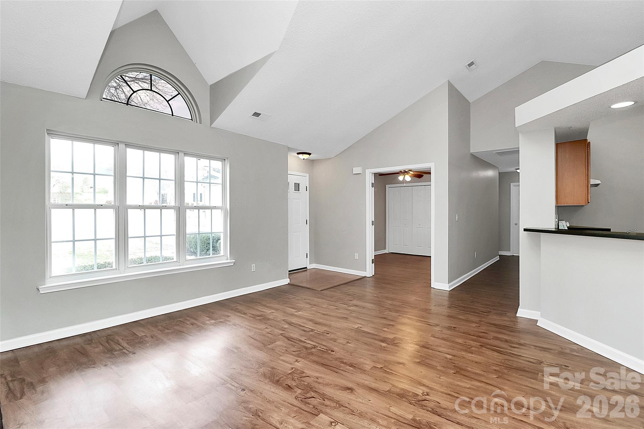 1044 Sandy Point Drive Southwest Concord, NC 28025 - Photo 6 of 32 wooden floor in an empty room with a window
