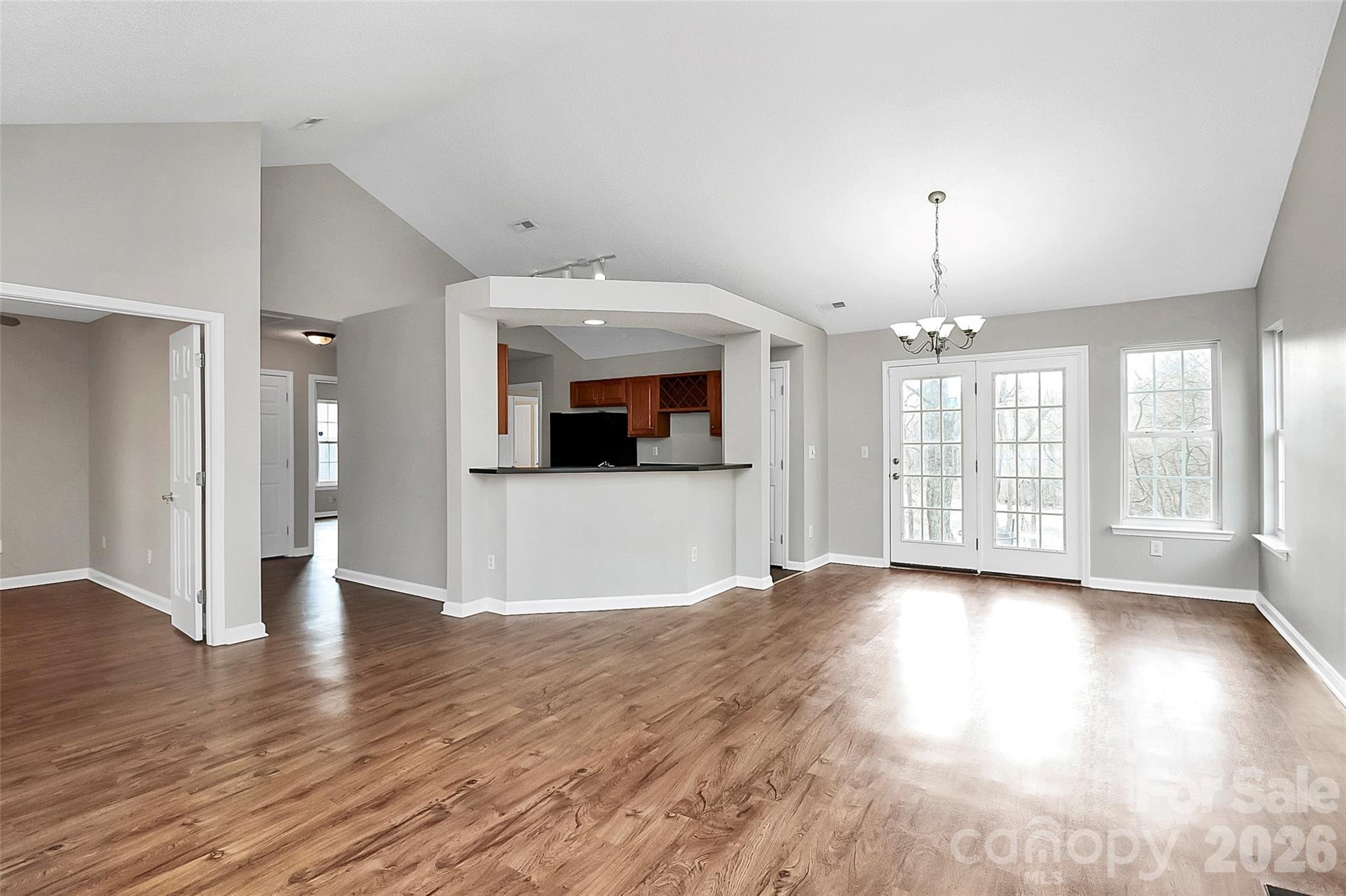 1044 Sandy Point Drive Southwest Concord, NC 28025 - Photo 8 of 32 a view of a big room with wooden floor and a kitchen