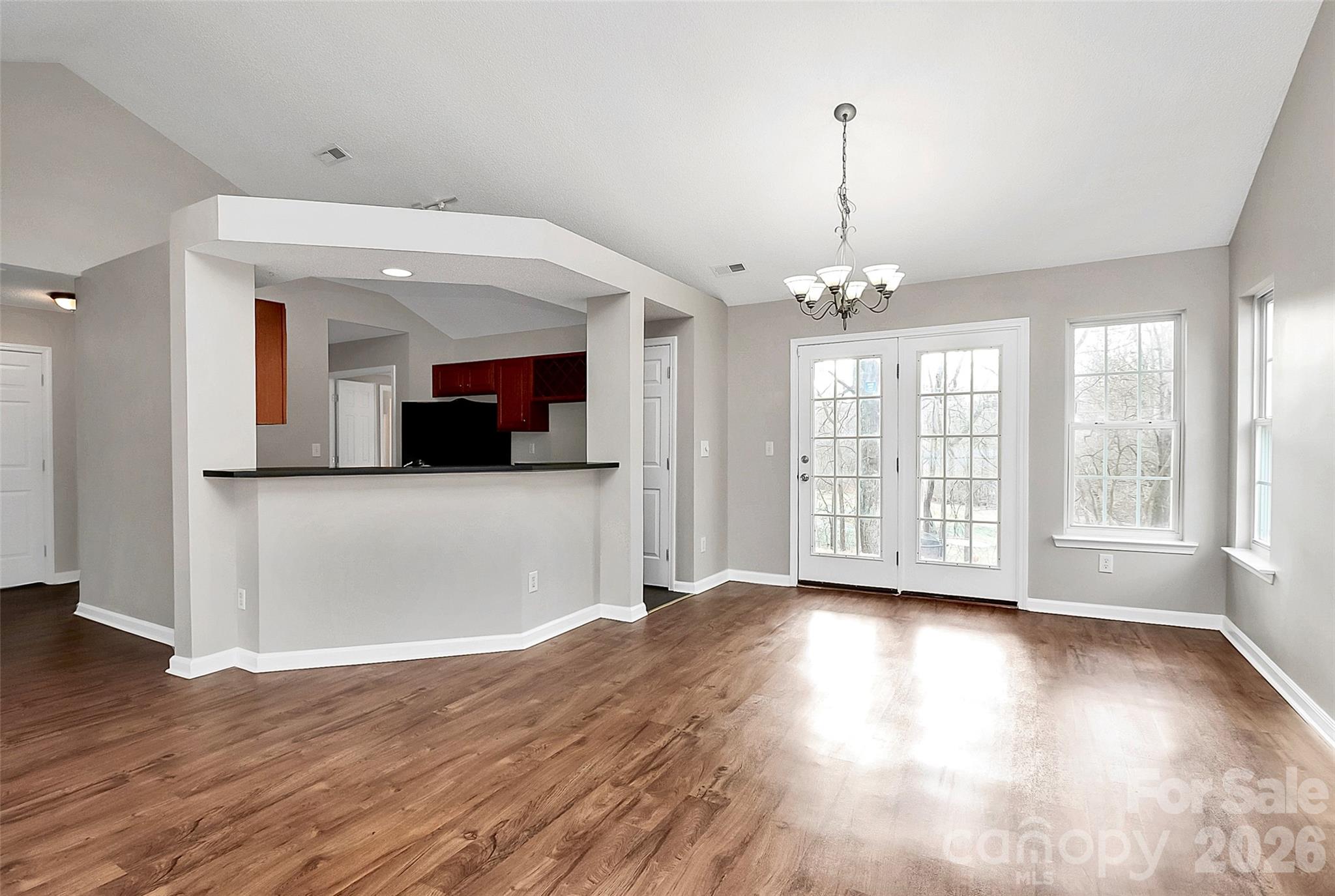 1044 Sandy Point Drive Southwest Concord, NC 28025 - Photo 9 of 32 a view of a room with wooden floor and chandelier