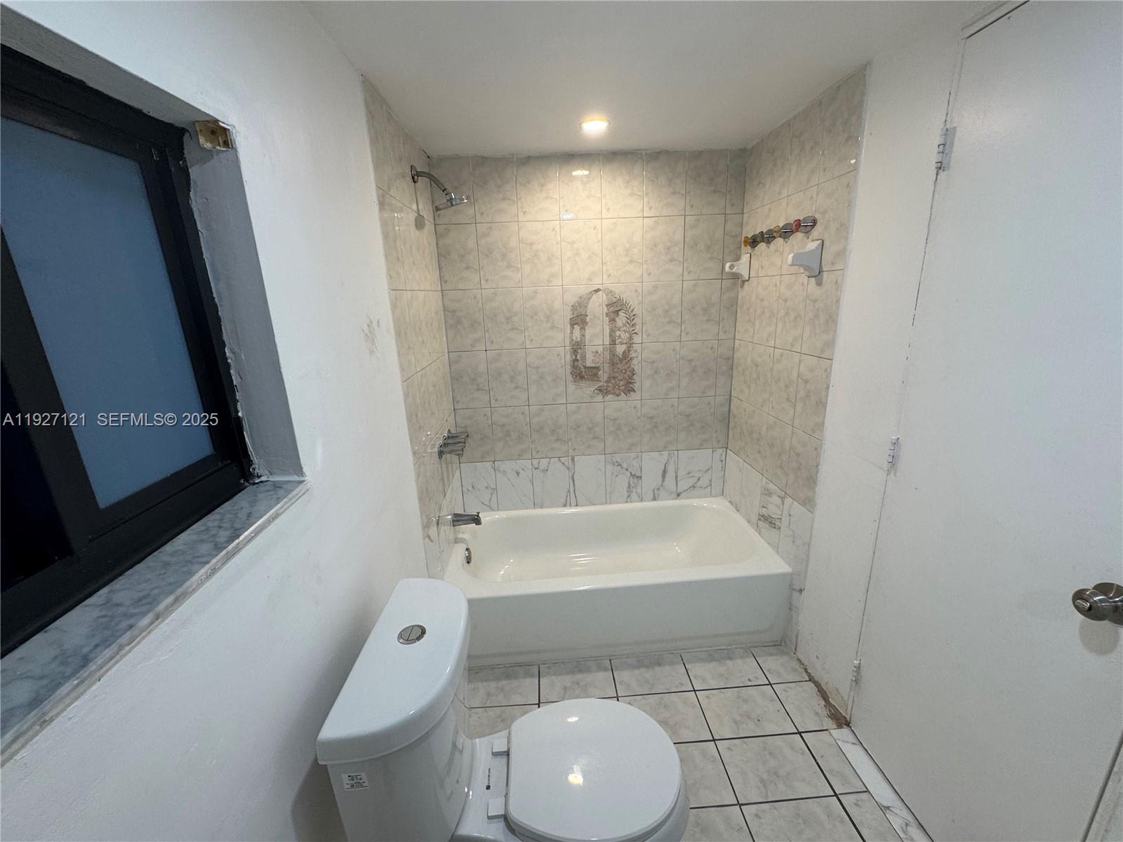 169 Northeast 50th Street, Unit 2 Miami, FL 33137 - Photo 16 of 16 a bathroom with a toilet a sink and bathtub