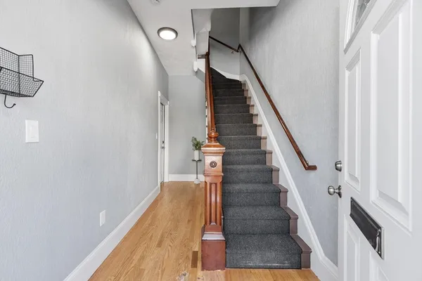 a view of entryway and gallery with wooden floor