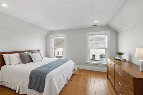 a bedroom with a bed and a night stand
