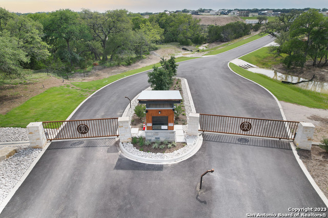 5386 Ranch Road 1376, Unit 191 Fredericksburg, TX 78624 - Photo 2 of 23 an aerial view of a house with a yard and a garden