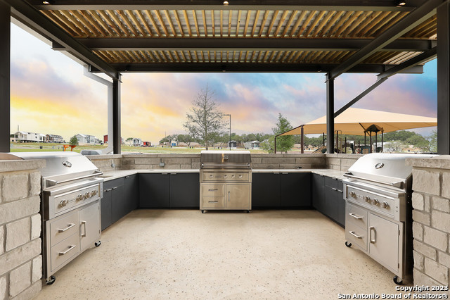5386 Ranch Road 1376, Unit 191 Fredericksburg, TX 78624 - Photo 22 of 23 a kitchen with stainless steel appliances kitchen island granite countertop a large kitchen counter top a sink and cabinets